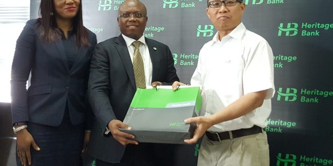 Mrs. Adaeze Udensi, Executive Director; Retail & SME Bank; Jude Monye, Executive Director Business Banking; who both represented the MD/CEO of Heritage Bank Plc, Ifie Sekibo; presenting a gift to the General Manager, Biase Plantations Limited (BPL), Mr. Ahmad Mustaffa Goh, at the signing ceremony of N232million Pilot Out-growers’ Agreement between the Bank and BPL at Heritage Bank’s Head Office, Lagos.