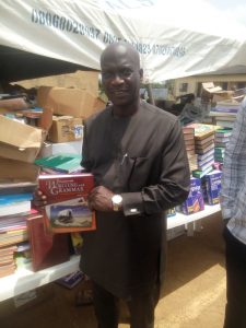 Hon. Wale Raji holding one of the donated books
