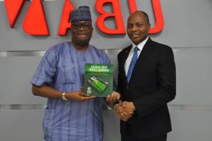 l-r: Founder Naija Green Card, Abimbola Daramola  and Head Digital & Consumer Banking, United Bank for Africa (UBA) Group, Mr.  Yinka Adedeji, during the official launch of the Naija Green Card Prepaid Card at the UBA house, Lagos